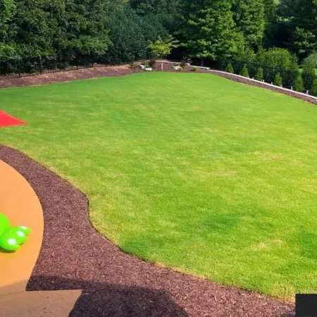 The stunning 'after' result in Alpharetta, GA: a vibrant, deep green sod lawn thriving thanks to a professionally installed and operating automatic landscape irrigation system.